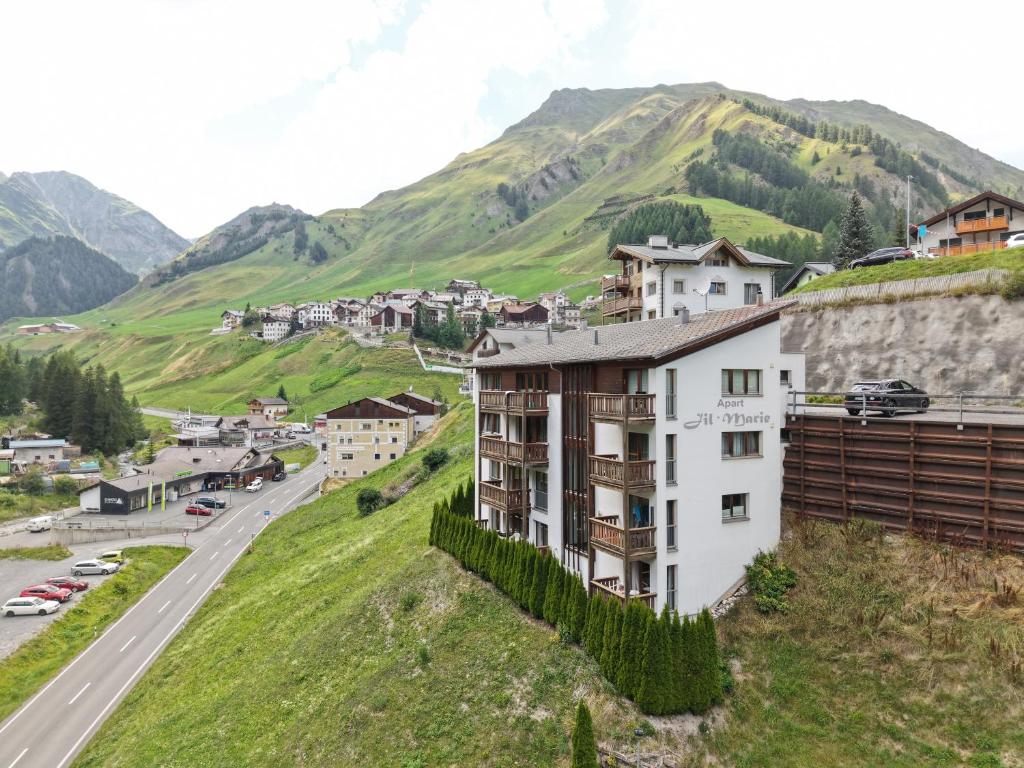a town on a hill next to a road at Apart Jil-Marie by MEIN SAMNAUN - MOUNTAIN HOMES in Samnaun
