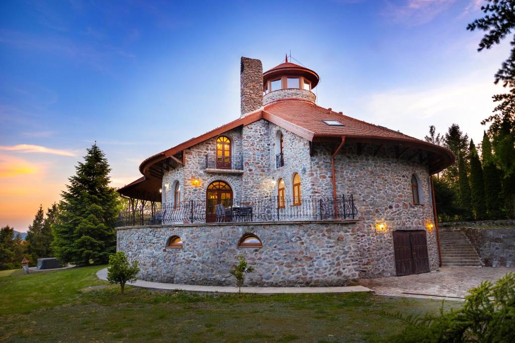 a large stone building with a tower on top at Jákób-Vár Vendégház in Füzér
