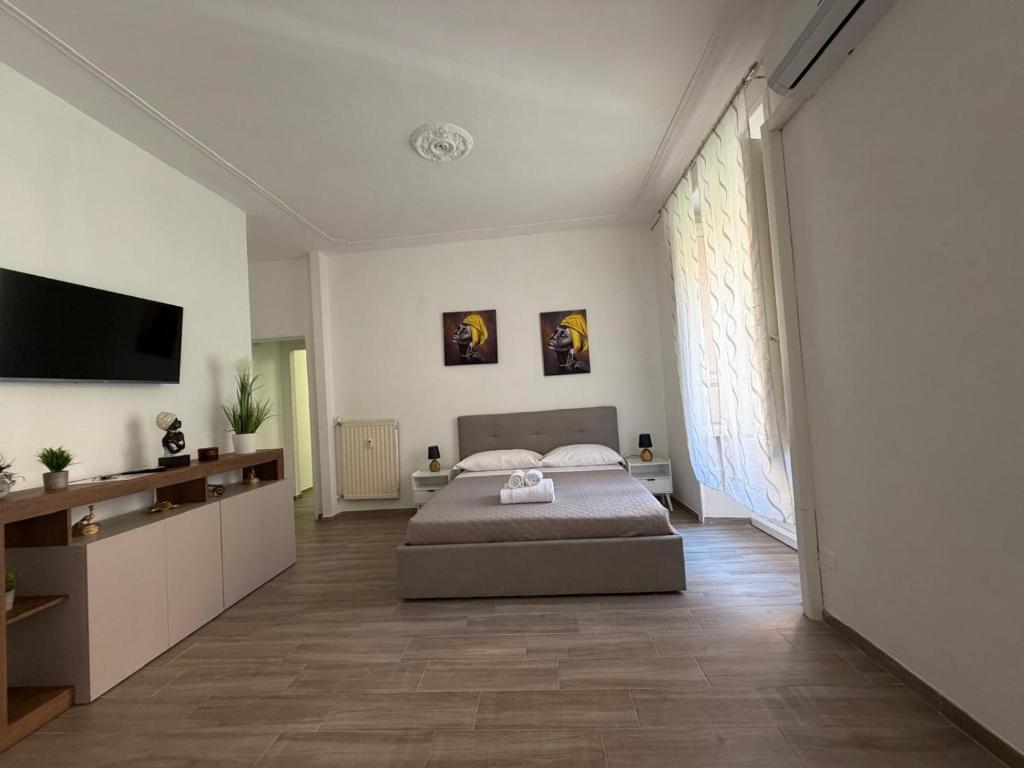a bedroom with a bed and a flat screen tv at Residence Emporium in Rome