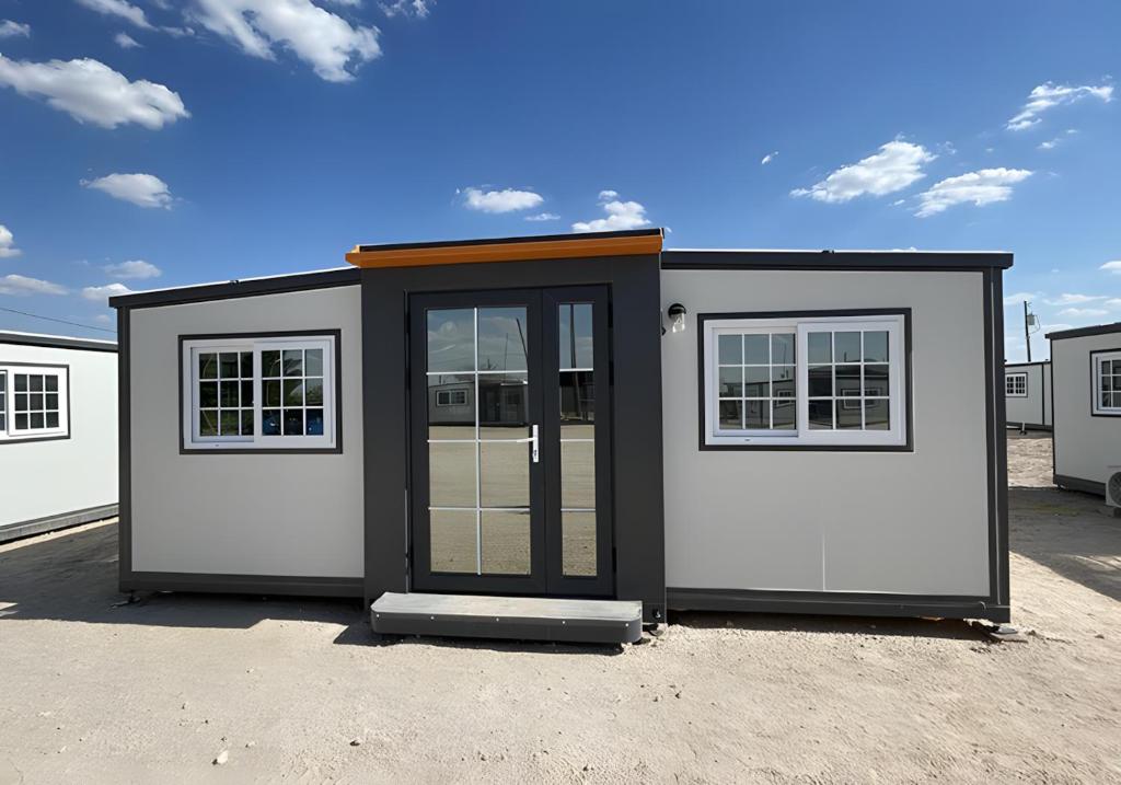 a small shed with a door and two windows at Box Villages Pecos in Pecos