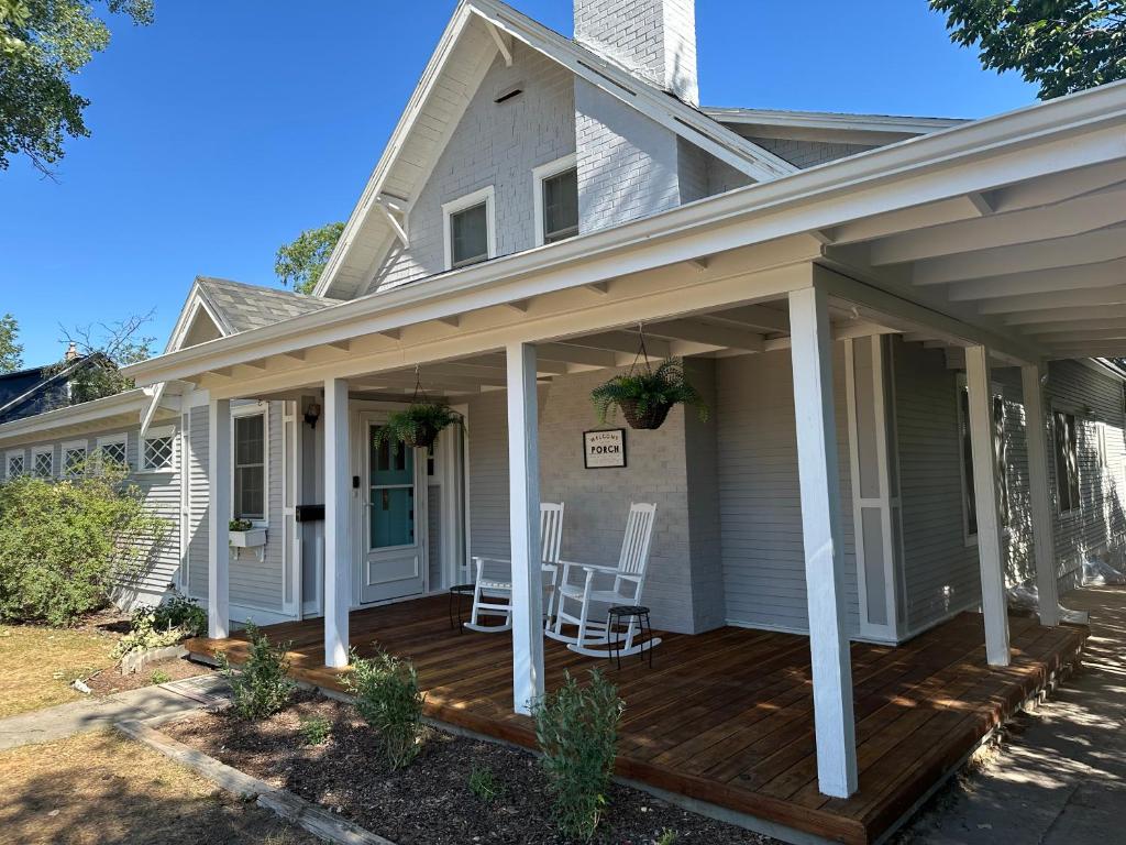 a porch of a house with two chairs on it at Pigeon's Roost on Rushmore in Rapid City