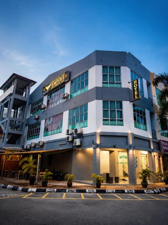 a building with a sign on the front of it at Hotel Empire Banting in Banting