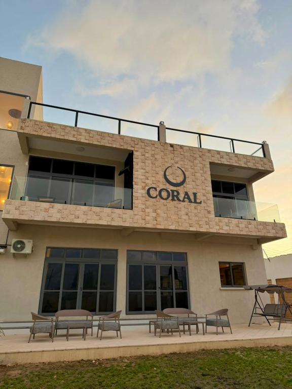 a building with a group of benches in front of it at Coral by Ivory Hotels in Mombasa