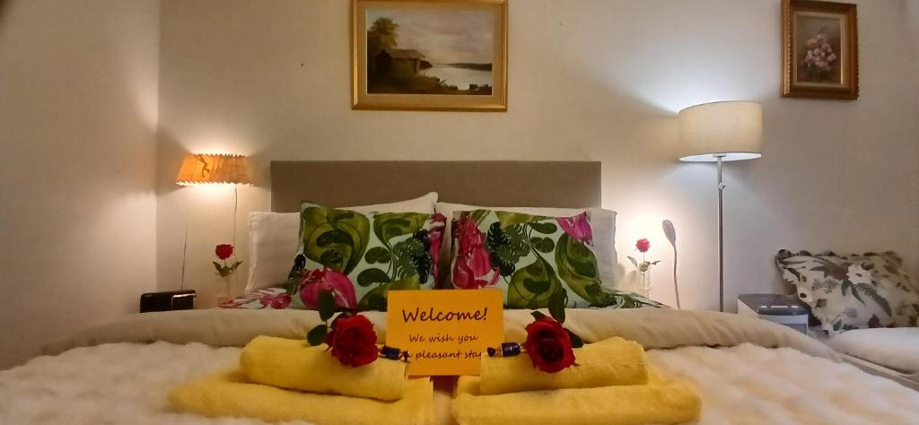 a room with a bed with a sign on it at Saimaa Parkview Luxury Suite in Savonlinna