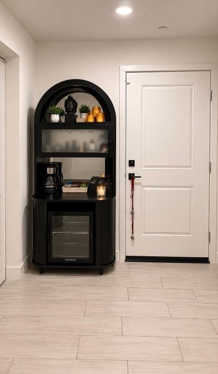 a room with a door and a table with a microwave at Private Dana Point Beach Studio in Dana Point