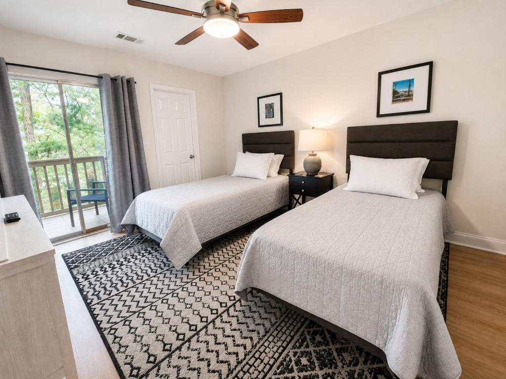a bedroom with two beds and a ceiling fan at 2Br 2Ba Condo on Golf Course in Pawleys Island