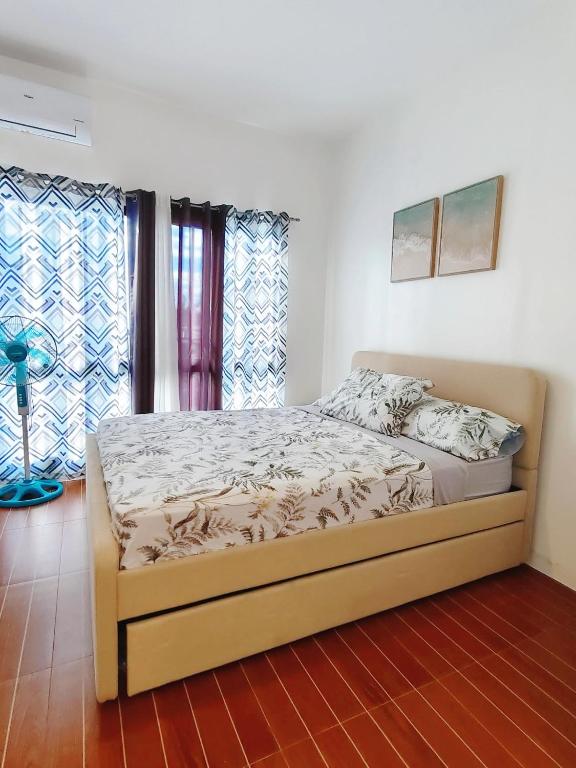 a bed in a room with windows and a bedvisor at Graceland in Lapu Lapu City