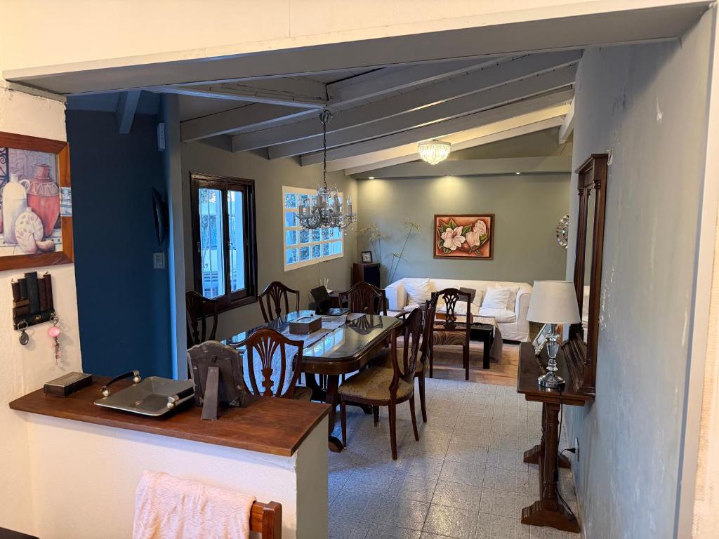 a dining room and living room with a table and chairs at Marea in San Lorenzo
