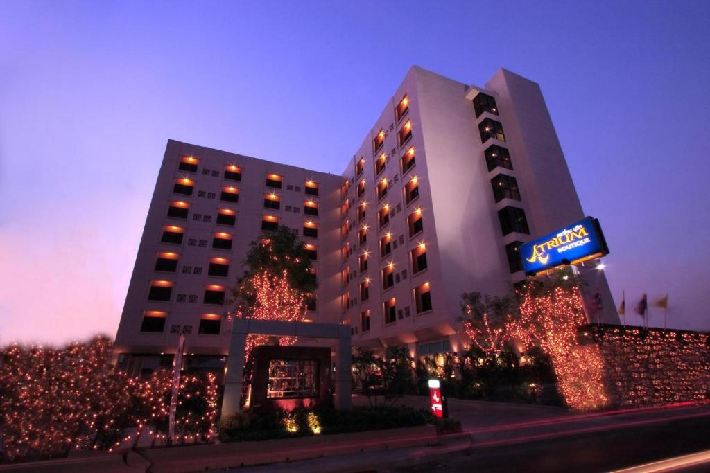 a hotel with christmas lights in front of a building at Atrium Boutique Hotel in Bangkok