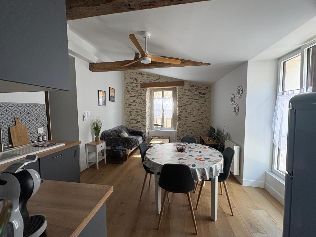 a kitchen and living room with a table and chairs at Maison de charme centre Pornic in Pornic