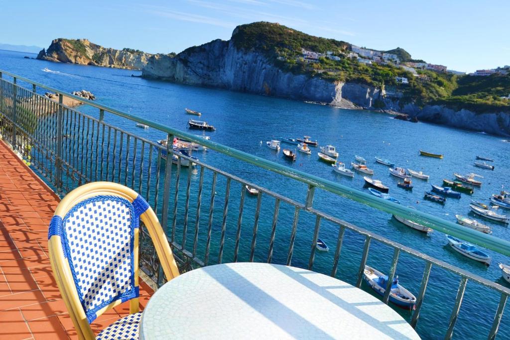 a table and chairs on a balcony overlooking a harbor at Maridea - Donatino a Mare in Ponza