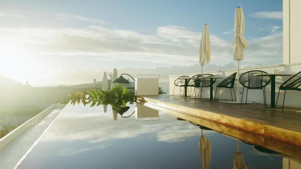 a table and chairs on top of a swimming pool at Memmo Alfama - Design Hotels in Lisbon