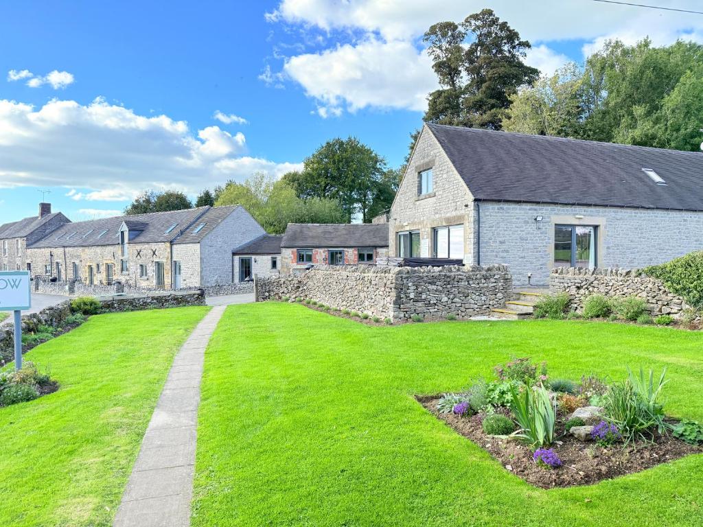 a house with a green lawn in front of it at Standlow Farm in Kniveton
