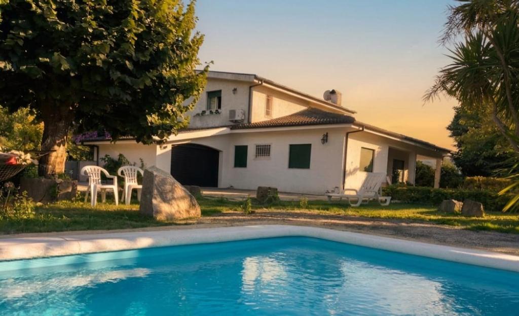 a house with a swimming pool in front of a house at Casa da Corredoura in Penafiel