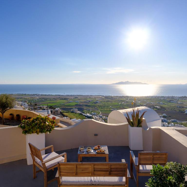 a view of the ocean from the balcony of a villa at Themis Goddess Cave Suites in Santorini