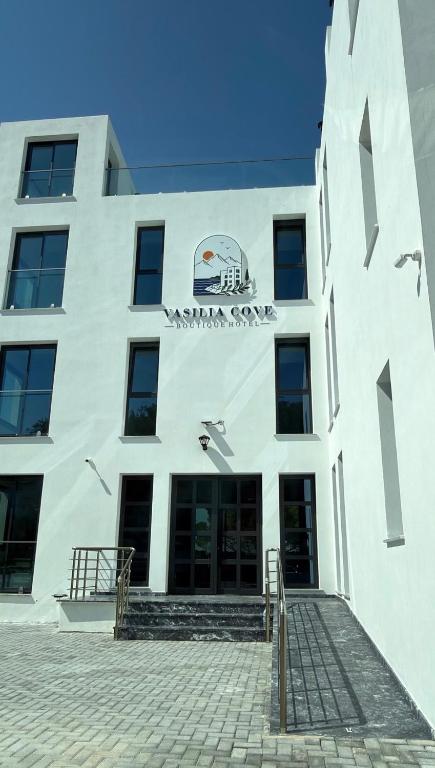 a white building with a sign on it at Vasilia Cove Boutique Hotel in Nicosia