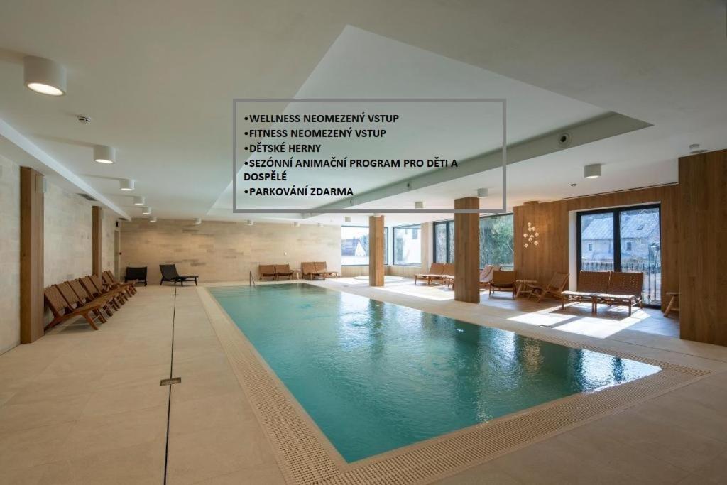 a large swimming pool in a large building at Resort Aurum in Černý Dŭl