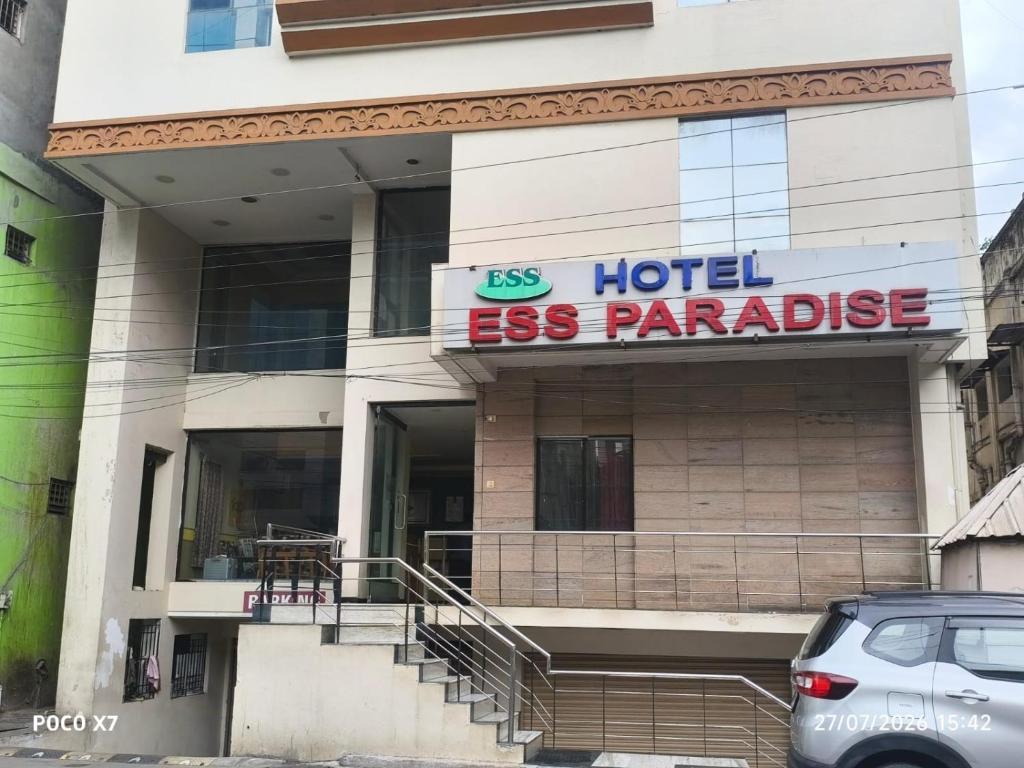 a hotel esparande building with a car parked in front at Hotel ESS Paradise in Coimbatore
