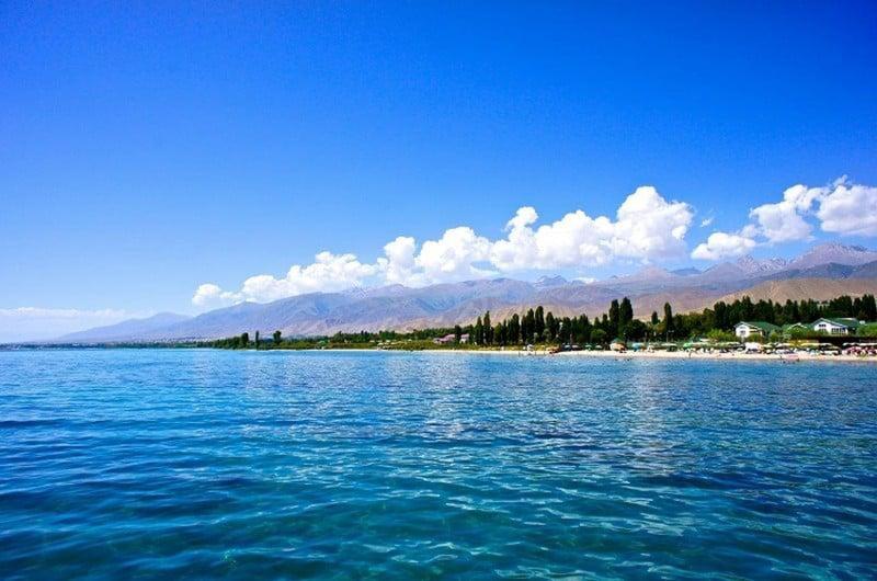 a large body of water with a beach in the background at Nazik Guest House in Barskoon