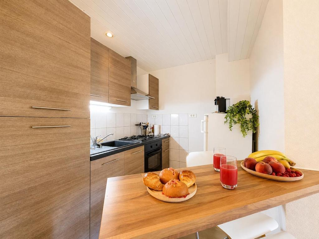 a kitchen with two plates of food on a wooden table at Le Condrieu in Vérin