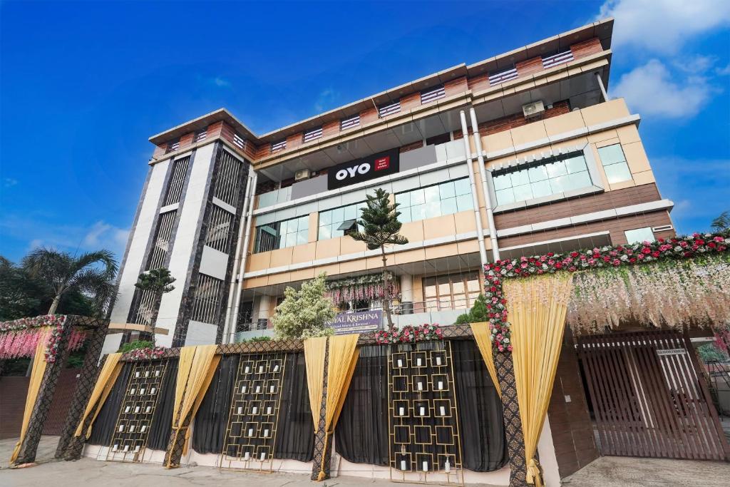 a building with gates and flowers in front of it at Hotel O Royal Krishna in Gorakhpur