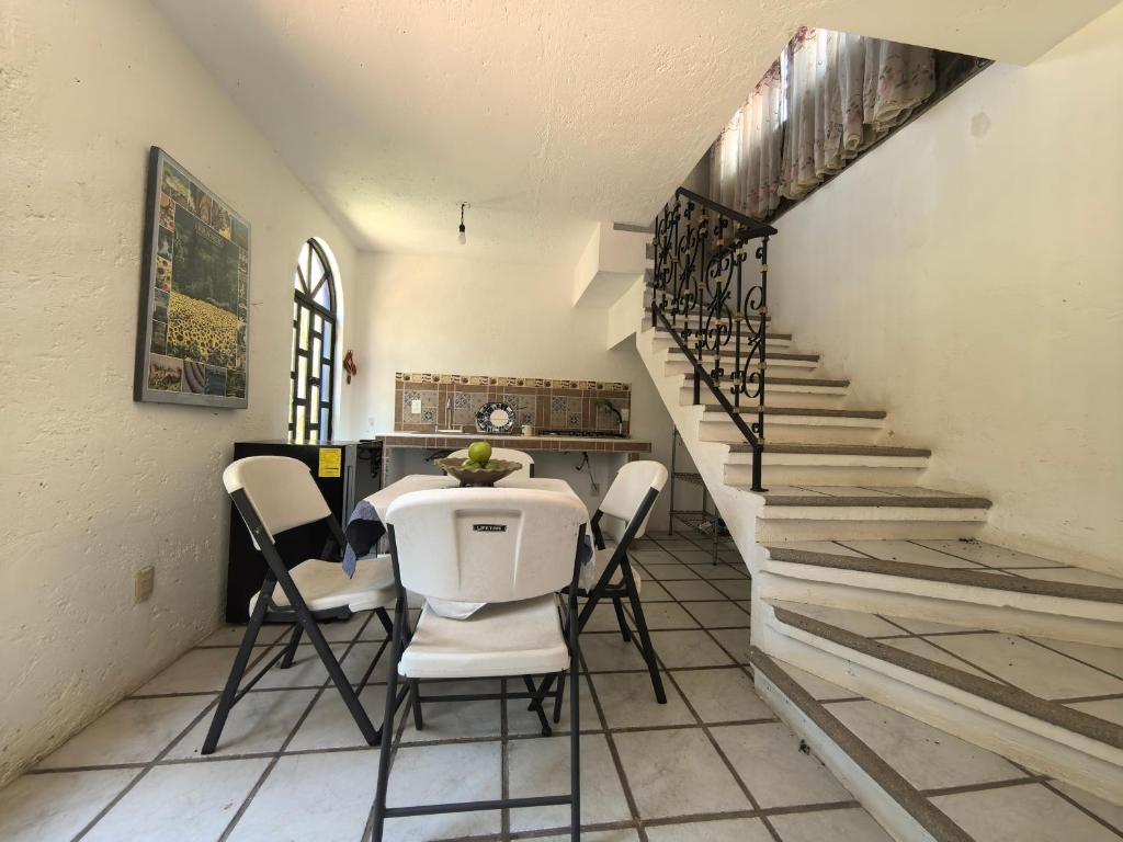 a dining room with a table and chairs and stairs at Quinta Luz de Luna in Jusnajal