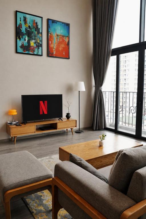 a living room with a tv and a couch at PentStudio Westlake - Cozy Duplex - New Apartment in Hanoi