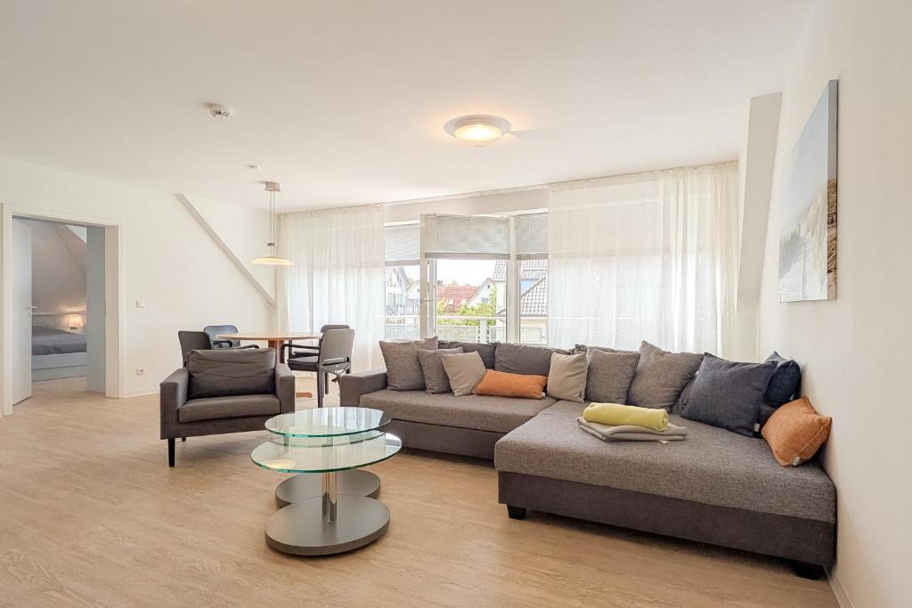 a living room with a couch and a table at Residenz Seestern Wohnung 32 in Boltenhagen