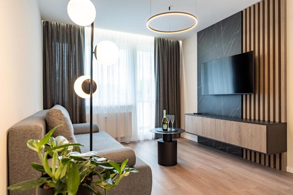 a living room with a couch and a television at MCK Apartments in Košice