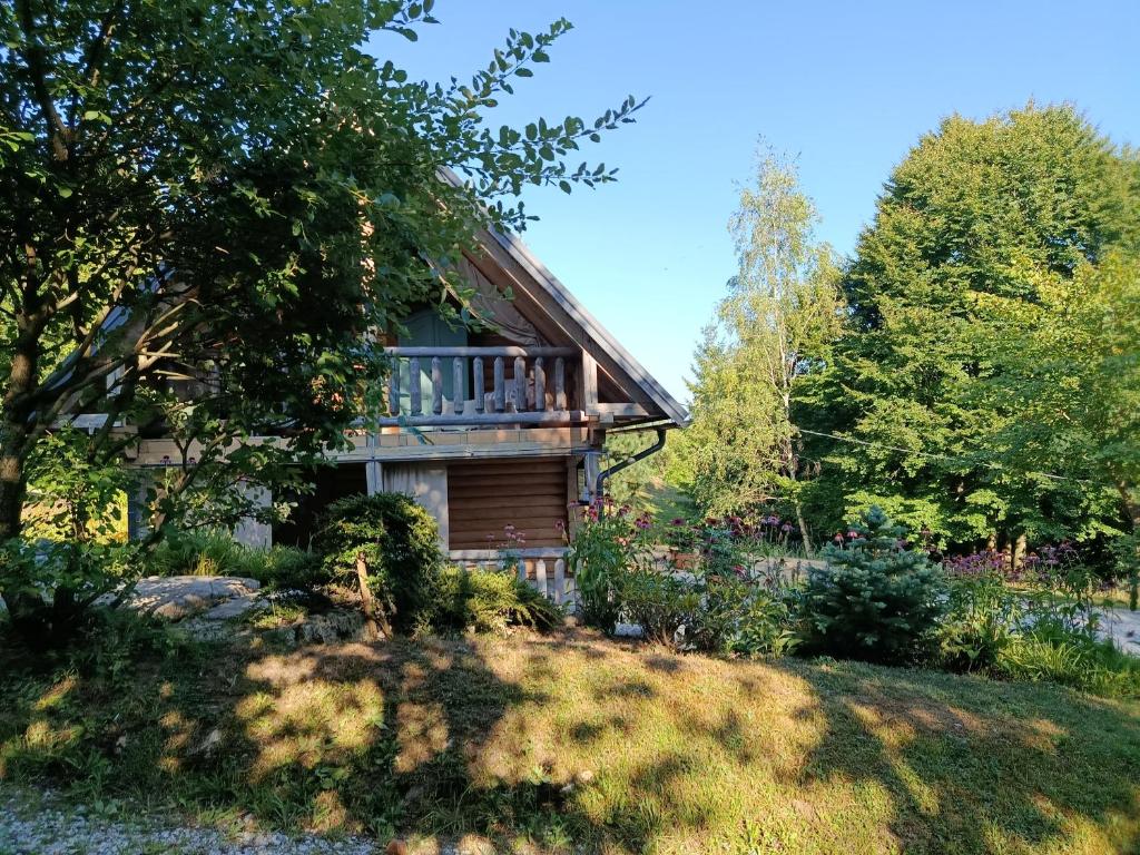 a house on a hill with trees in front of it at Lill' Hill estate & wellness - Lumina Chalet in Idrija