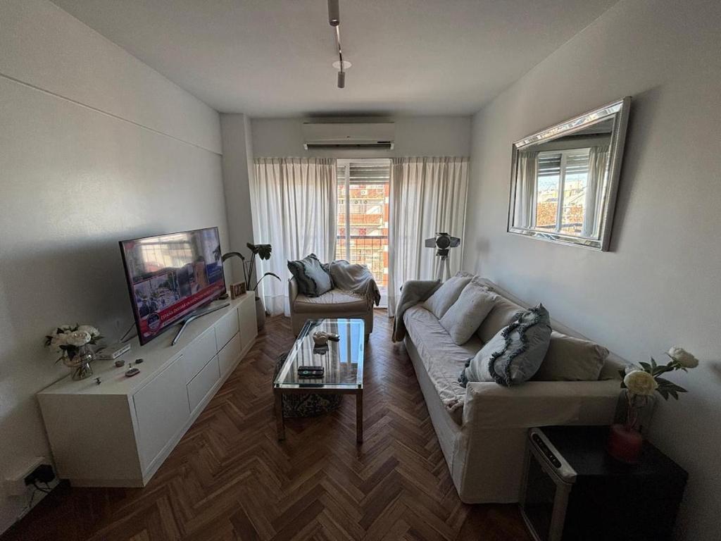 a living room with a couch and a tv at my depto in Vicente López