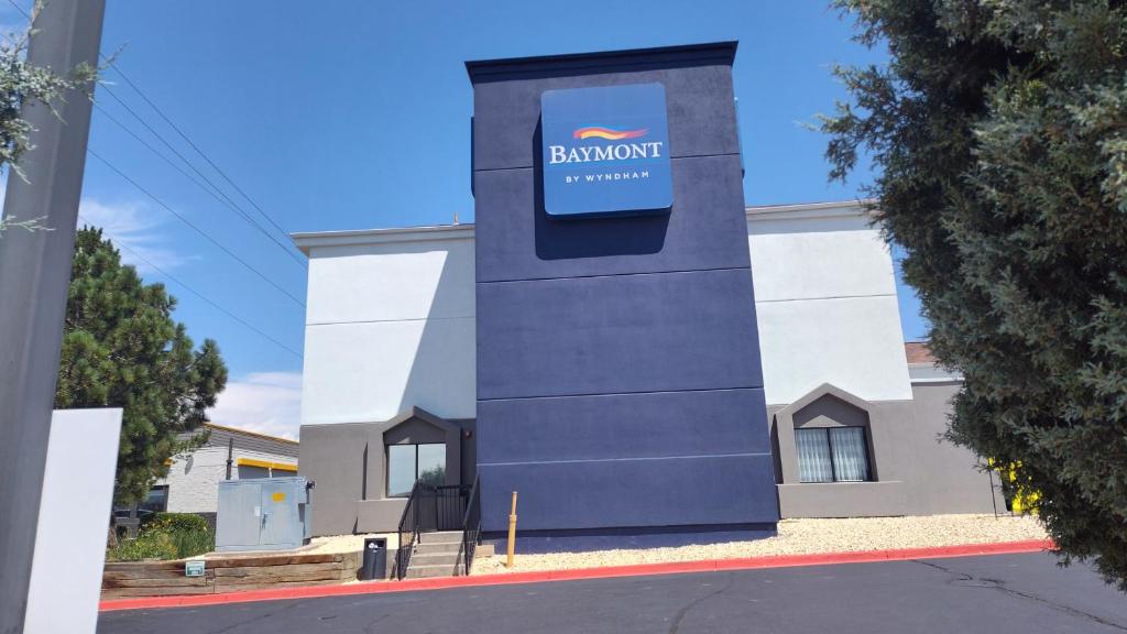 a building with a sign on the side of it at Baymont by Wyndham Fort Collins in Fort Collins