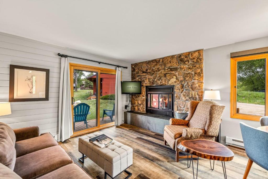 a living room with a couch and a fireplace at Mustang in Clark