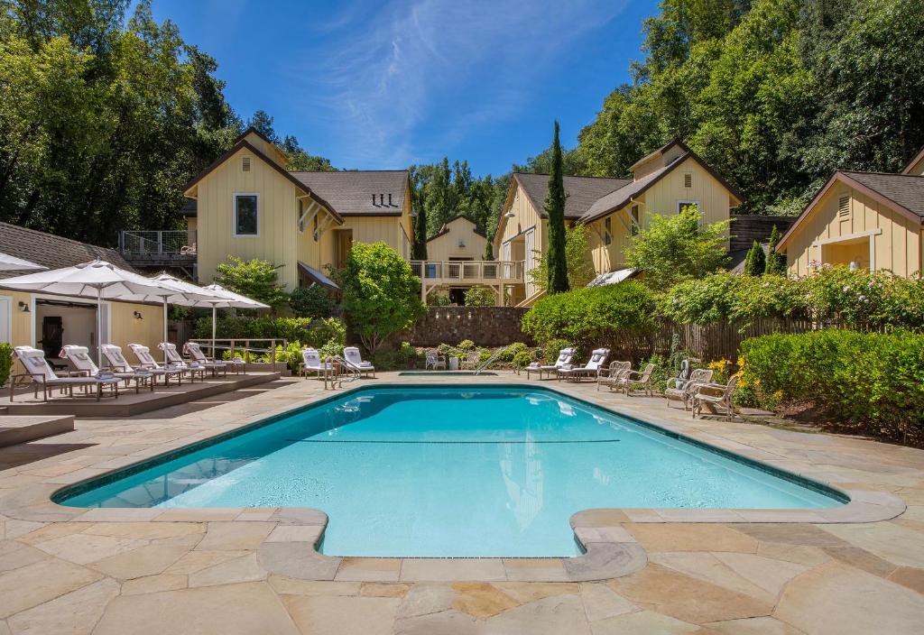 a swimming pool in front of a house at Farmhouse Inn in Forestville
