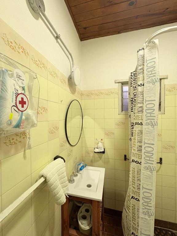 a bathroom with a sink and a shower curtain at Villa Valeria in General Acha
