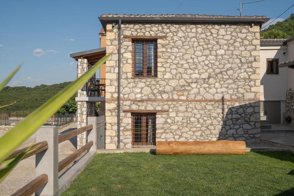 a stone building with a yard in front of it at Penelope Suites With View Meteora in Kalabaka
