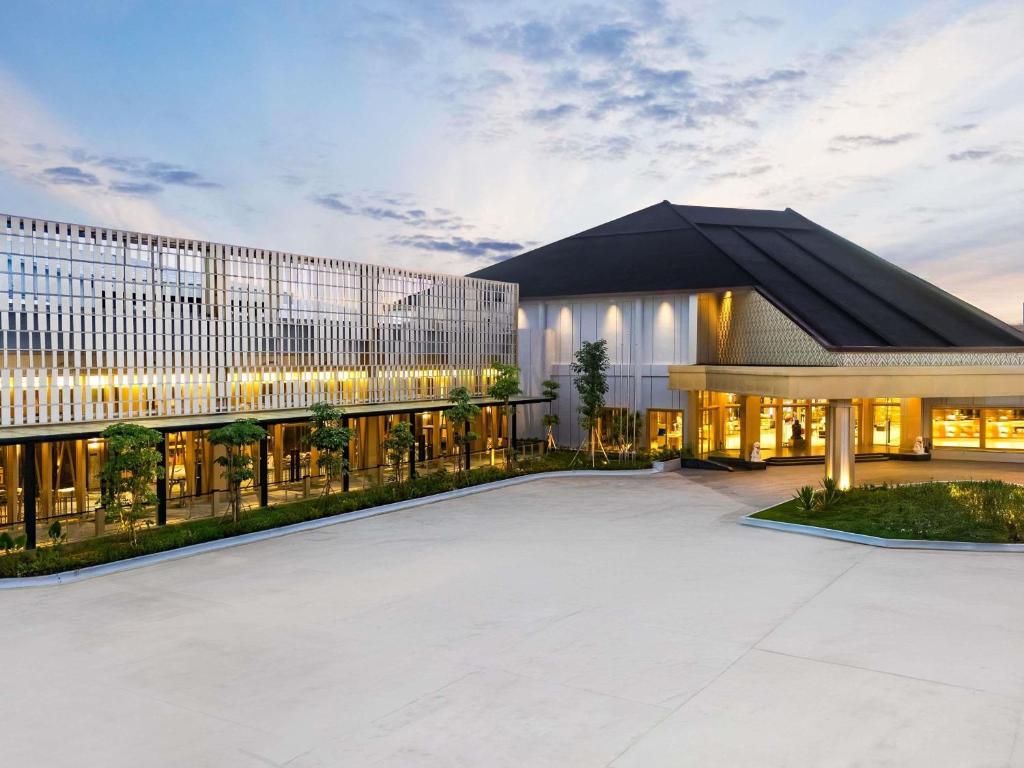 a large building with a lot of windows at Novotel Pontianak Convention Centre in Pontianak