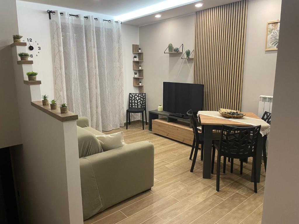 a living room with a couch and a table at La Via delle Rose in Alimena