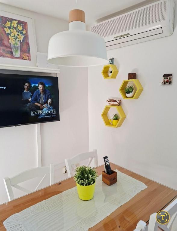 a living room with a table and a tv at Apartment Megi in Supetar historical core in Supetar