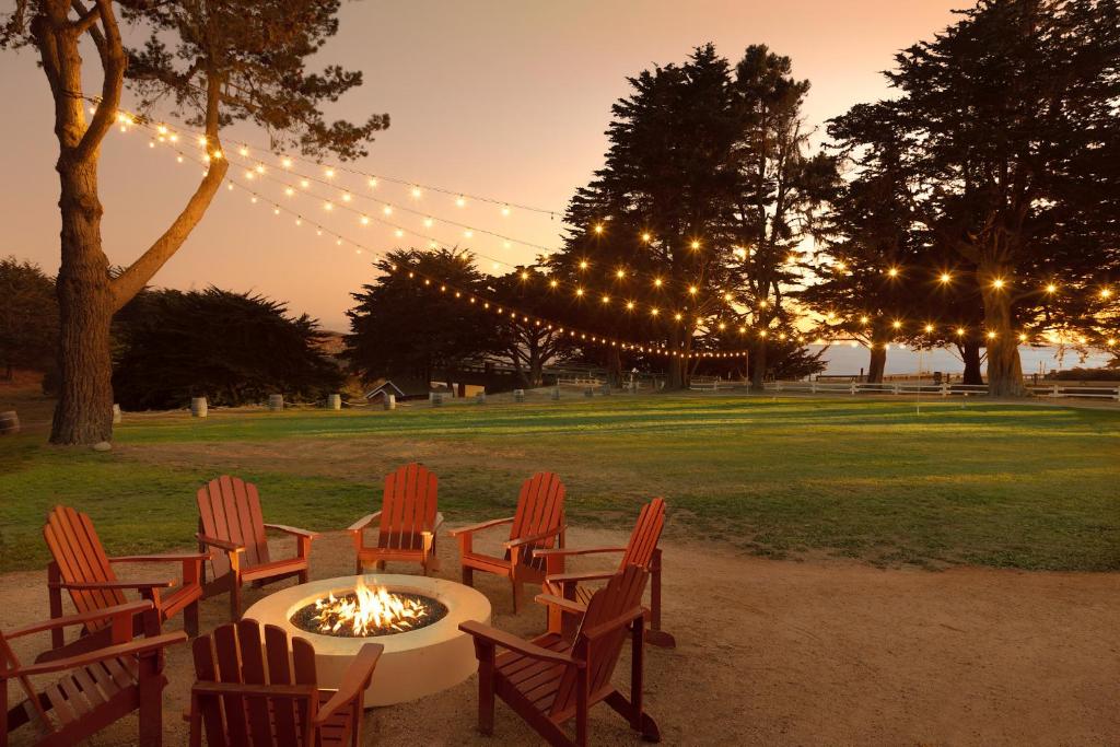 a group of chairs around a fire pit in a park at Oceanpoint Ranch in Cambria
