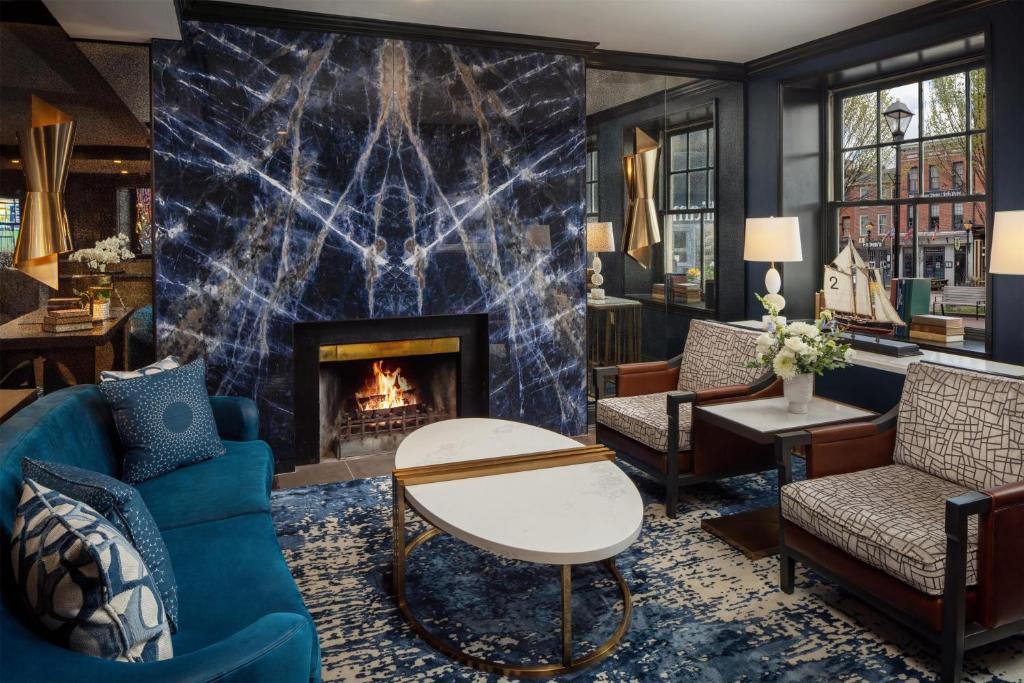 a living room with a fireplace and furniture at The William Fell Baltimore, Tapestry Collection by Hilton in Baltimore