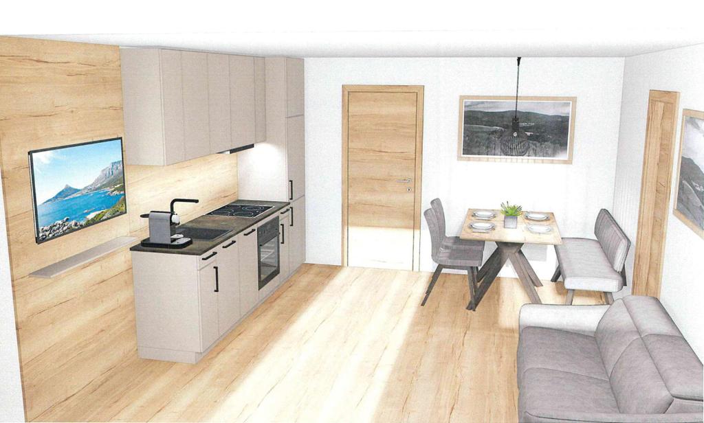 a kitchen and a living room with a table at Glücksmoment in Kaunerberg