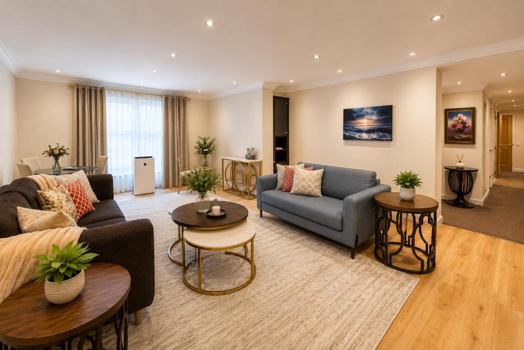 a living room with two couches and tables at Spacious 3BR Lancaster Gate Near Hyde Park in London