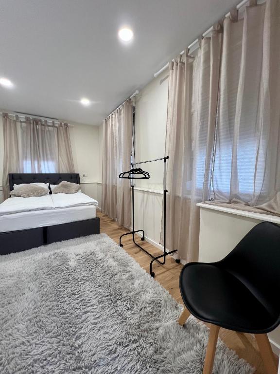 a bedroom with a bed and a chair and a rug at Apartment Marin in Bad Wildbad
