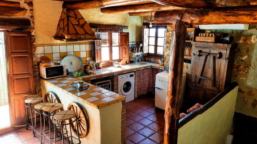 a kitchen with a sink and a stove top oven at Casa Nazari in Benaocaz