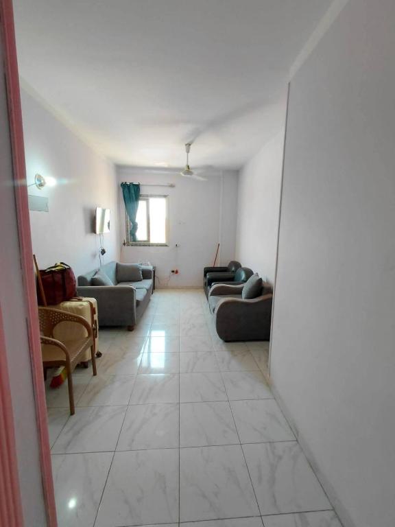 a large living room with couches and a window at Cairo gust house in Alexandria