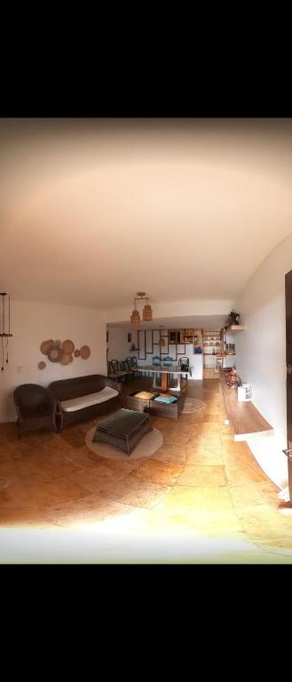 a large room with couches and tables in it at Casa Maravilha in Aquiraz