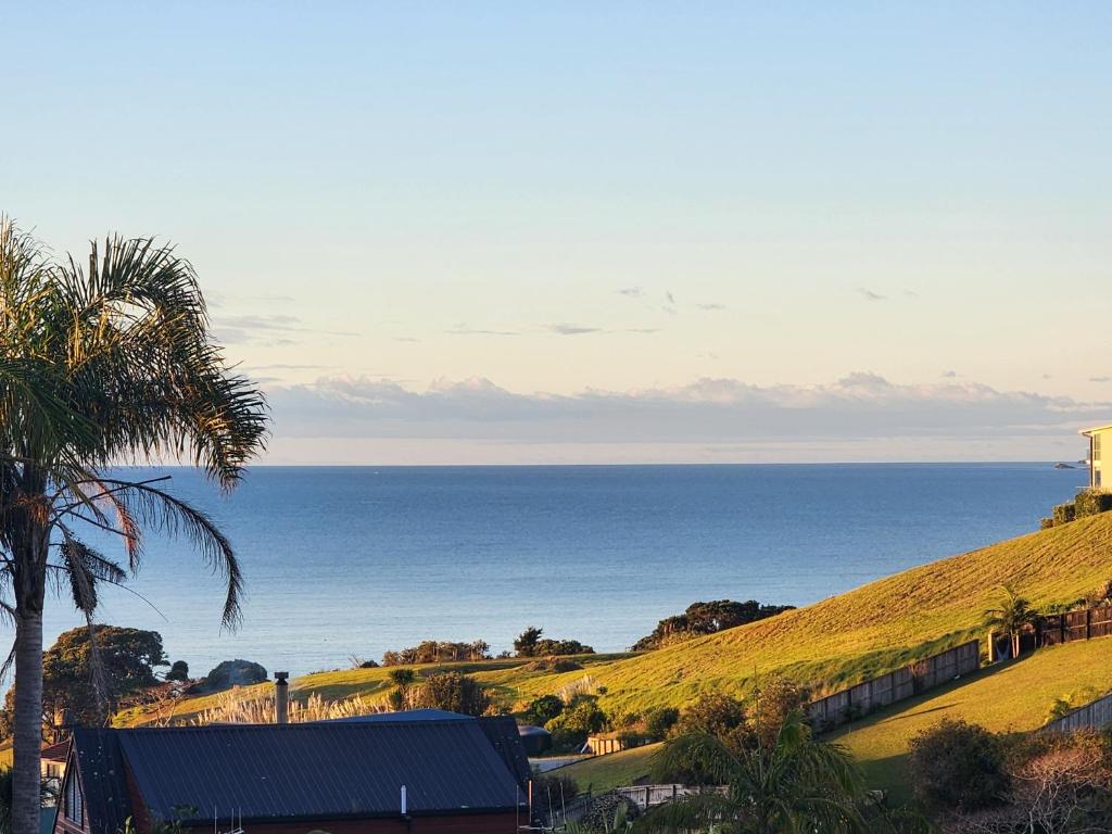 a view of the ocean from a house at Darlene's Nest in Cable Bay