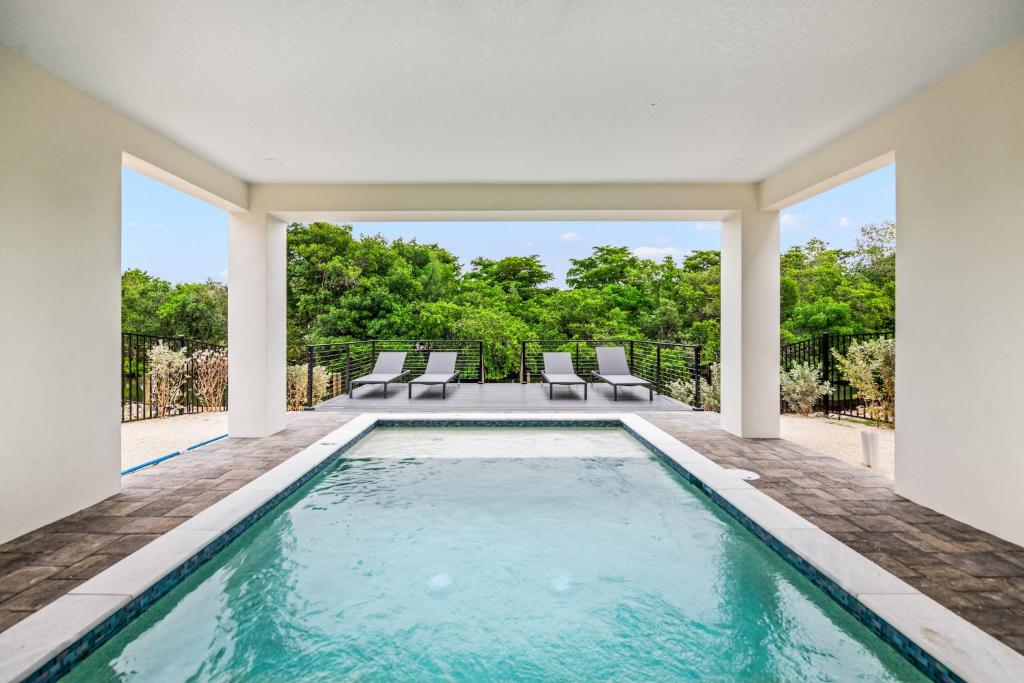 an indoor swimming pool in a house with a patio at Salty Seagull at Hunters Point in Cortez