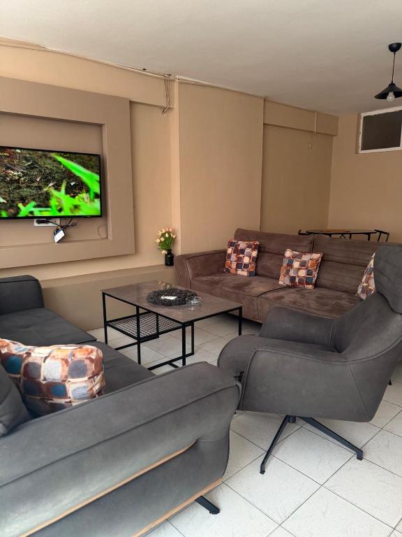 a living room with couches and a flat screen tv at Pendik ar Marmaray Pet Friendly in Istanbul